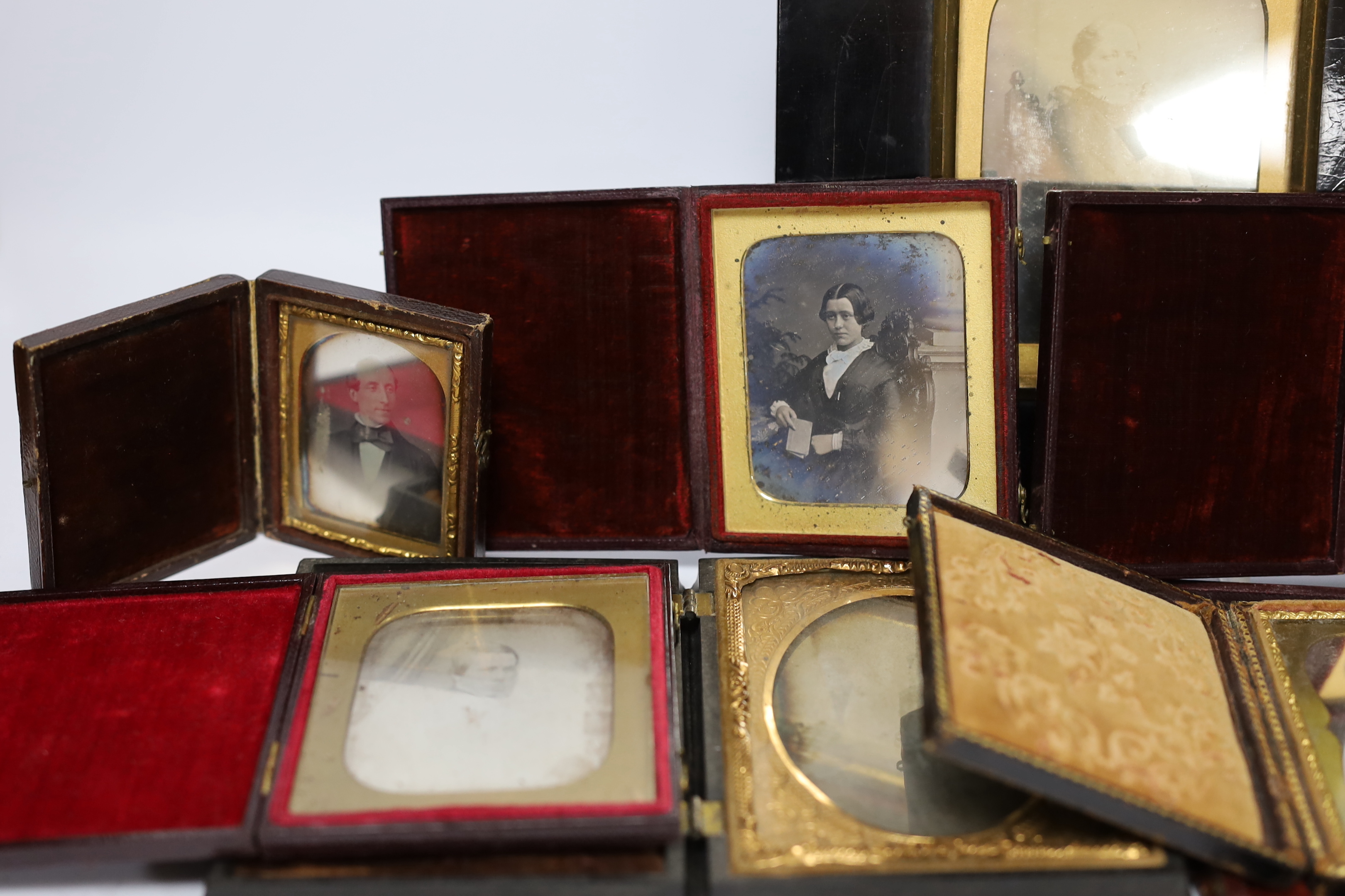 Nine mid 19th century daguerreotype portrait photographs, all mounted in brass, etc. frames, some in decorative cases, one example framed